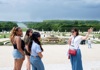 A tour guide explaining the history of the Place of Versailles.