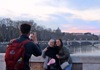 Two women having their picture taken on Ponte Sisto in Rome. 