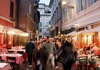 A group of tourists walking through Trastevere at night while on tour with The Tour Guy.