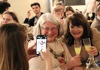 Two women having their picture taken while drinking limoncello.