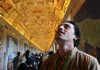 A tourist looking at the ceiling at the gallery of maps in the Vatican Museums 
