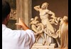 Tourists looking at Lacoon and His Sons inside the Vatican Museums.