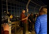 A group of tourists standing on the Eiffel Tower listening to a guide from The Tour Guy.