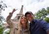A couple in front of the Eiffel Tower in Paris.