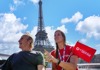 A tourist on a Seine River Cruise near the Eiffel Tower with their guide from The Tour Guy.