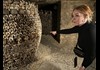 Girl pointing the barrel of passion at catacombs in Paris