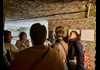 Group of people talking in the catacombs 
