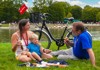 A family having a picnic next to the Grand Canal of Versailles while on tour with The Tour Guy.