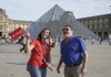 A man in front of the Louvre Pyramid with a guide from The Tour Guy.