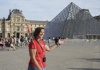A tour guide outside of the Louvre Pyramid while giving a tour for The Tour Guy.