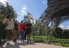 Tourists walking in front of the Eiffel Tower while on a tour with The Tour Guy.