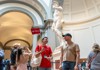 A man in front of the Statue of David in the Accademia Gallery with his guide from The Tour Guy.
