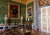 A tour group taking pictures of the grand rooms in the Versailles' Place.