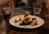 An image of biscotti and wine on a table.