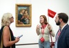 Two people in front of Madonna and Child with Saints in the Uffizi Gallery while on tour with The Tour Guy.