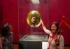 A woman looking at Medusa by Caravaggio in the Uffizi Gallery while listening to her guide from The Tour Guy.
