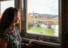 A woman looking out to Ponte Vecchio in Florence.