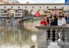 A group of tourists in front of Ponte Vecchio with a guide from The Tour Guy.