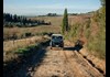 Jeep on dirt path in Tuscany