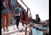 people walking along coast