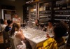 Women pouring wine into beaker