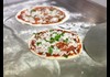 Pizzas on steel flattop