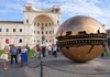 A group of tourists walking through the Pinecone Courtyard in the Vatican Museums while on tour with The Tour Guy.