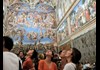 A group of tourists nside the Sistine Chapel