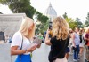 A pair of tourists standing in front of the Vatican.