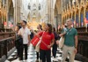 A group of tourists inside Westminster Abbey with a guide from The Tour Guy.