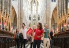 A group of tourists inside Westminster Abbey with a guide from The Tour Guy.
