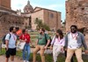 A group of tourists in front of the Senate House in the Roman Forum with their guide from The Tour Guy.