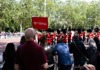 A man looking at the Changing of the Guard ceremony in St. James Park while on tour with The Tour Guy.