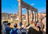 A group of tourists walking through Pompeii with their guide from The Tour Guy.