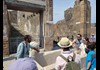 A group of tourists looking at the Thermal Baths of Pompeii with their guide from The Tour Guy.