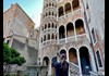 A family sitting on a gondola in Venice.