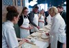 people making pasta in a kitchen