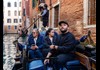 A man having his picture taken in front of Rialto Bridge while on tour with The Tour Guy.