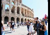 A group of tourists in front of the Colosseum with their guide from The Tour Guy.