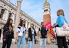 A group of tourists in front of Doge's Palace with a guide from The Tour Guy.