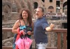 A couple having their picture taken at the Colosseum.