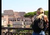 A woman looking at the Colosseum.