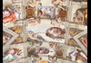 An image of The Creation of Adam inside the Sistine Chapel.