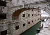 A picture of the Bridge of Sighs with a gondola passing under.