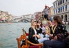 A group of friends on a gondola in Venice.