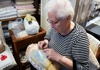 An older woman hand stitching lace designs on Burano Island.