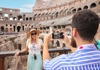 A woman having her picture taken at the Colosseum.