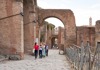 A group of tourists walking through the Palatine Hill