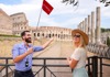 A woman standing near the Colosseum with her guide from the Tour Guy.