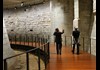 A tourist walking through the Medieval Louvre, the ruins of the Château du Louvre.